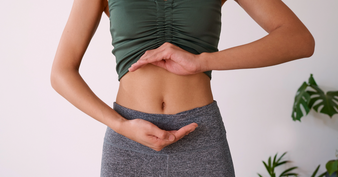 An image of a woman's abdomen with her hands cradling her stomach to emphasize gut health and benefits of BPC-157