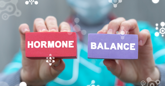 A close up image of a health care professional's hands holding blocks that read "hormone balance" emphasizing natural hormone support over 40 and stacking peptides for hormone health