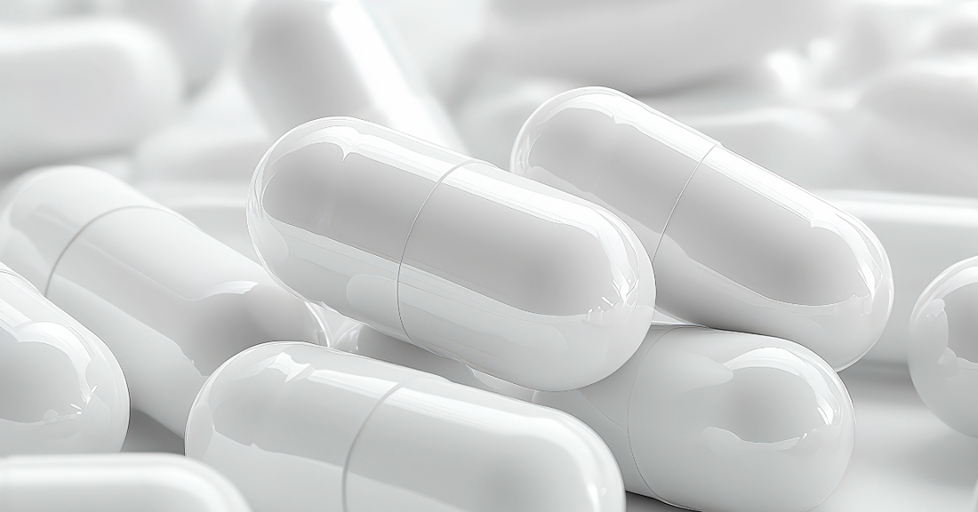 A close up image with white peptide capsules emphasizing the quality of USA made peptide capsules BPC-157, GHRP-2, CJC-1295, Alpha-GPC, Nootropic, Brain Boost