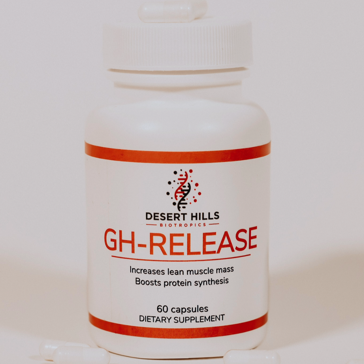 Desert Hills GH-Release peptide capsules supplement bottle with capsules scattered around the bottle on a light background