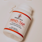 Desert Hills Mind-Tap peptide nootropic capsules supplement bottle with capsules scattered around the bottle on a light background